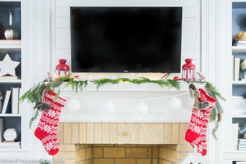 A Christmas fireplace with a TV over the mantle at Wife In Progress.
