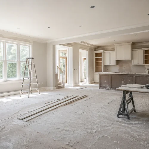 Wide shot of a freshly renovated room with a fine layer of construction dust on the floor and surfaces cleanup